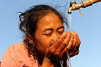 Lebenselixier: Eine Frau in Laos genießt Trinkwasser. Die Landeskirche tritt für das Menschenrecht auf Wasser ein. Foto: epd
